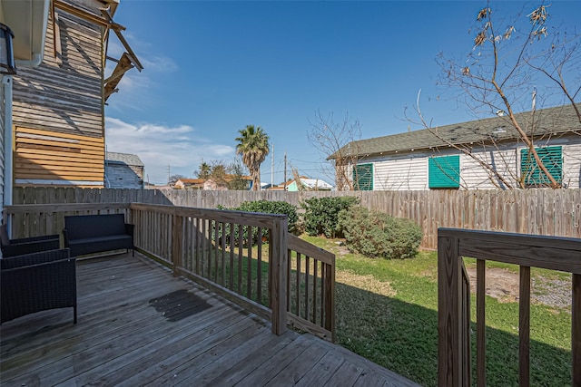 deck with a yard and a fenced backyard