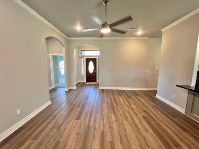 foyer with visible vents, crown molding, ceiling fan, baseboards, and dark wood-style floors