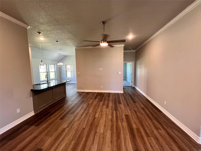 unfurnished living room featuring dark wood finished floors, crown molding, baseboards, and a textured ceiling