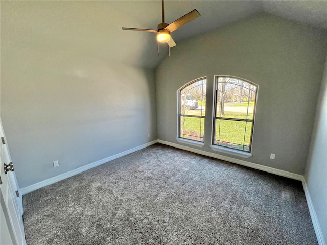 carpeted empty room featuring high vaulted ceiling, a ceiling fan, and baseboards