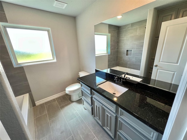 bathroom with vanity, toilet, baseboards, and visible vents