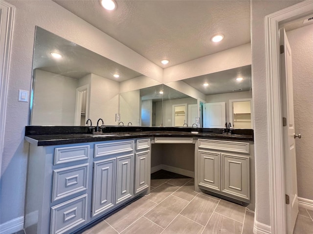 bathroom with a sink, recessed lighting, and double vanity