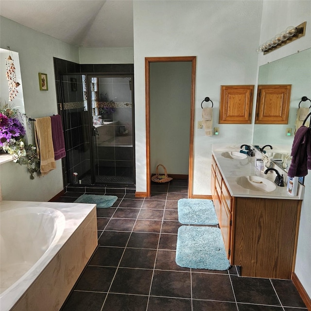 full bath with tile patterned floors, a shower stall, and a sink