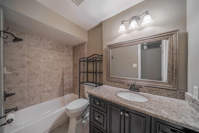 full bathroom with tile patterned floors, toilet, vanity, and washtub / shower combination