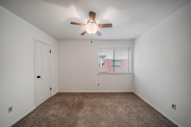 spare room with baseboards, a ceiling fan, and carpet flooring