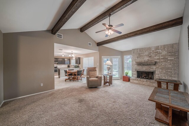 living area with visible vents, light carpet, a fireplace, and ceiling fan with notable chandelier