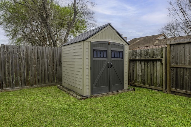 view of shed featuring a fenced backyard