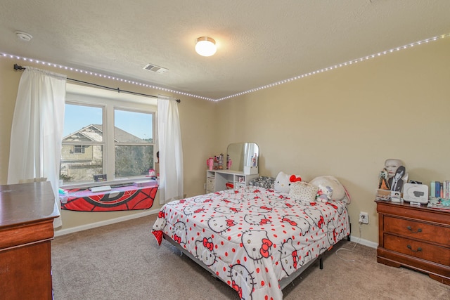 carpeted bedroom featuring visible vents, a textured ceiling, and baseboards