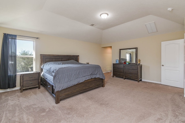 bedroom featuring baseboards, lofted ceiling, light colored carpet, and visible vents