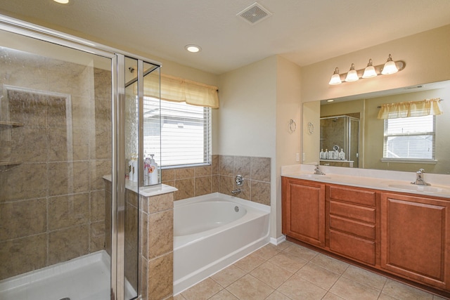 bathroom featuring a sink, visible vents, a shower stall, and tile patterned floors