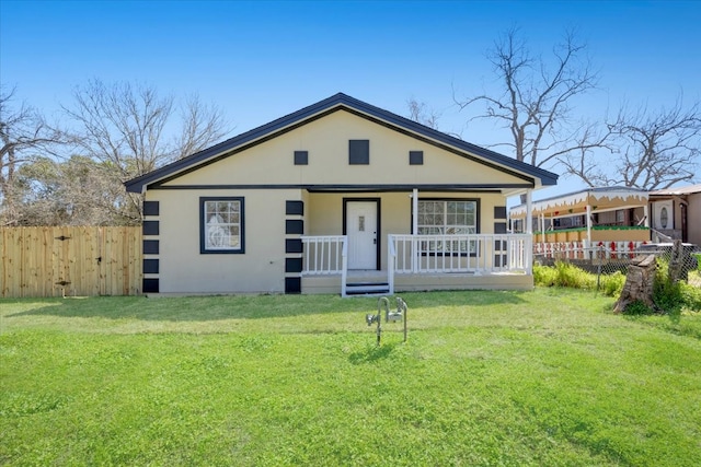 bungalow-style home with covered porch, a front lawn, and fence