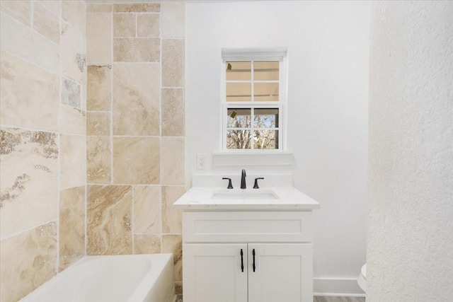 full bathroom featuring toilet, a washtub, and vanity