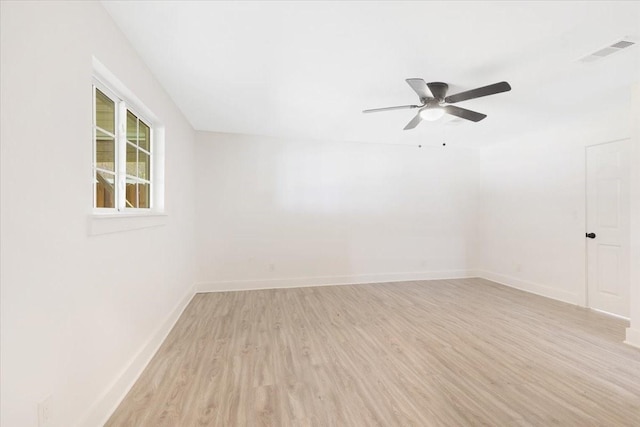 unfurnished room with visible vents, a ceiling fan, light wood-type flooring, and baseboards