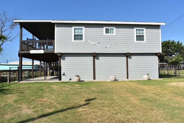 back of property with a lawn, a fenced backyard, and a gate