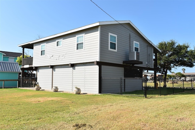 rear view of house featuring a yard and fence