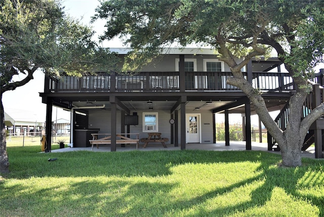 rear view of house with a yard and a patio area