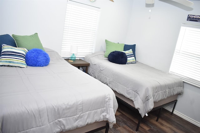 bedroom featuring wood finished floors, baseboards, and ceiling fan