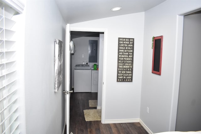 hall featuring washing machine and clothes dryer, baseboards, lofted ceiling, electric panel, and dark wood-style floors