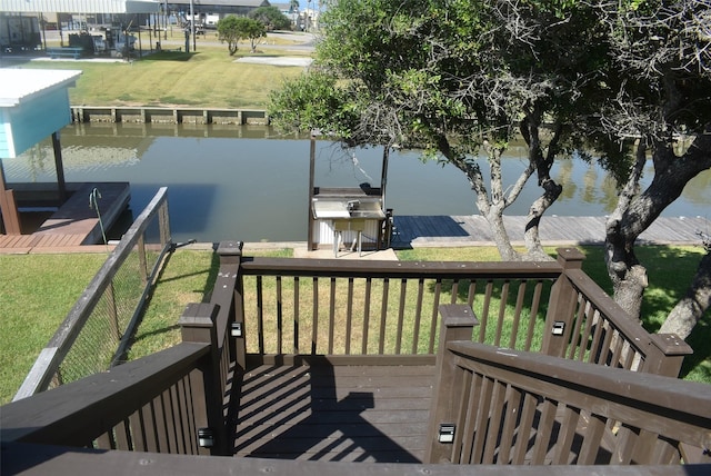 wooden terrace featuring a yard, a water view, area for grilling, and a dock