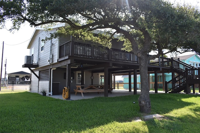 back of house featuring fence, stairway, central AC, a lawn, and a patio