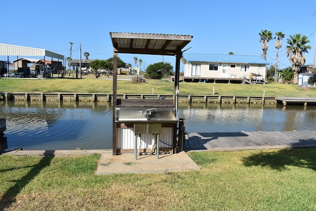 view of dock with a water view and a lawn