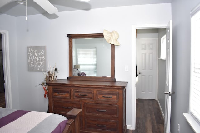 bedroom with dark wood-style flooring