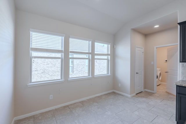 interior space with washer and clothes dryer and baseboards