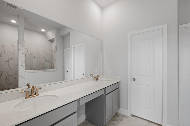 full bath with double vanity, visible vents, marble finish floor, and a sink