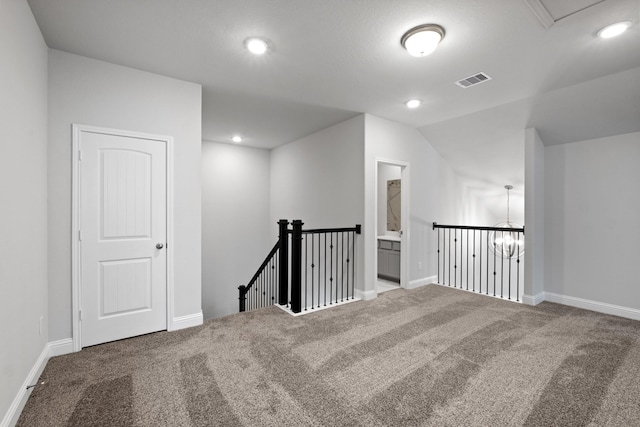 carpeted empty room featuring recessed lighting, visible vents, and baseboards