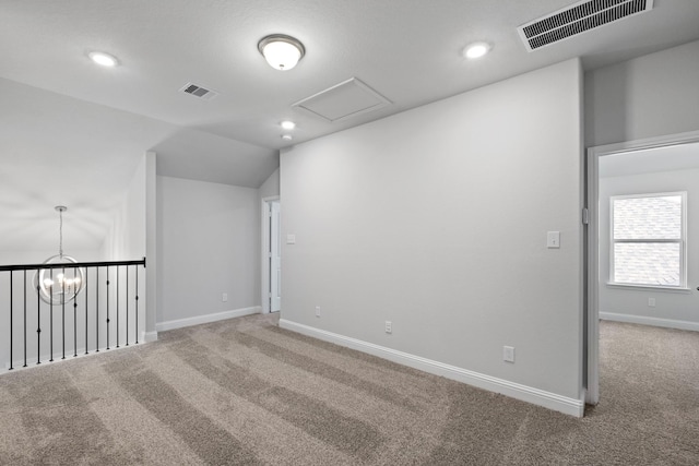 carpeted spare room with recessed lighting, visible vents, baseboards, and vaulted ceiling