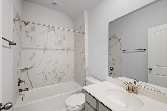 bathroom with tub / shower combination, toilet, vanity, and vaulted ceiling