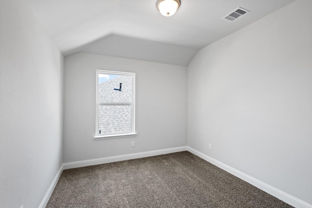 bonus room with vaulted ceiling, visible vents, baseboards, and dark colored carpet