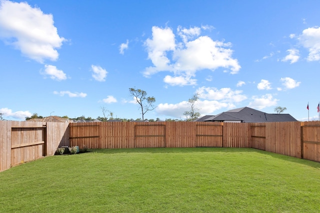 view of yard with a fenced backyard