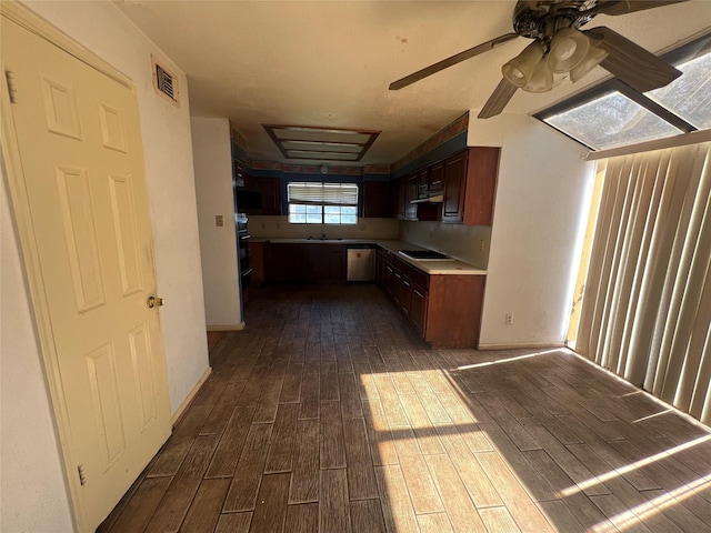 kitchen featuring visible vents, wood tiled floor, dishwashing machine, black cooktop, and a sink