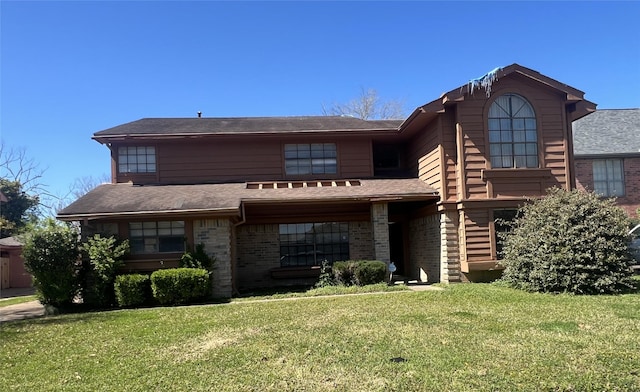 view of front of home with a front lawn and brick siding