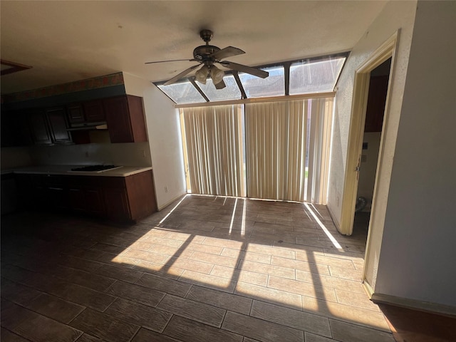 interior space with a healthy amount of sunlight, light countertops, gas cooktop, and a ceiling fan