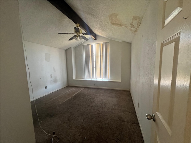 carpeted spare room featuring a ceiling fan, baseboards, a textured ceiling, and vaulted ceiling with beams