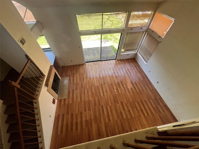 unfurnished living room featuring visible vents, stairs, and wood finished floors