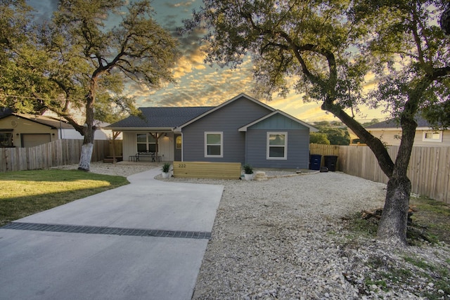 single story home with a lawn, board and batten siding, and fence