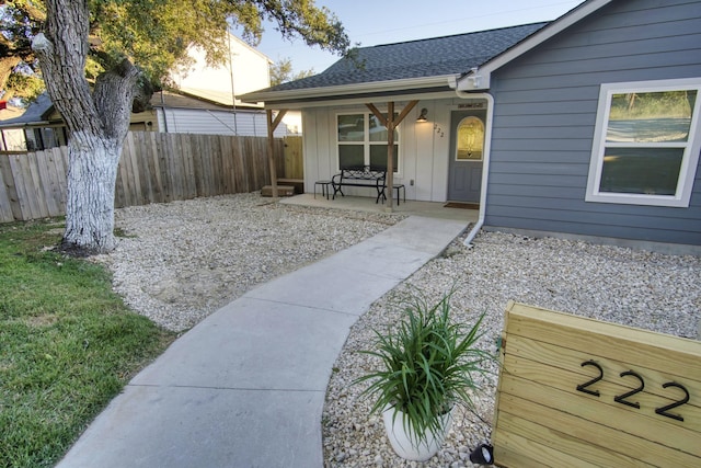 exterior space with a porch and fence