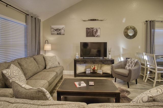 living room featuring lofted ceiling and wood finished floors