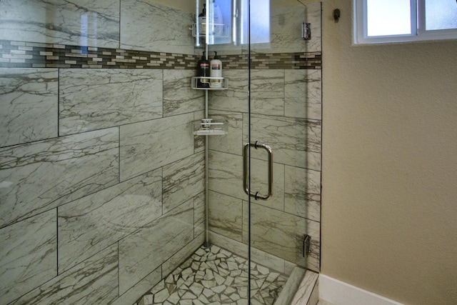 full bath featuring baseboards and a stall shower