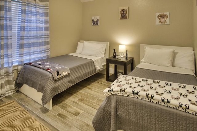 bedroom featuring wood finish floors