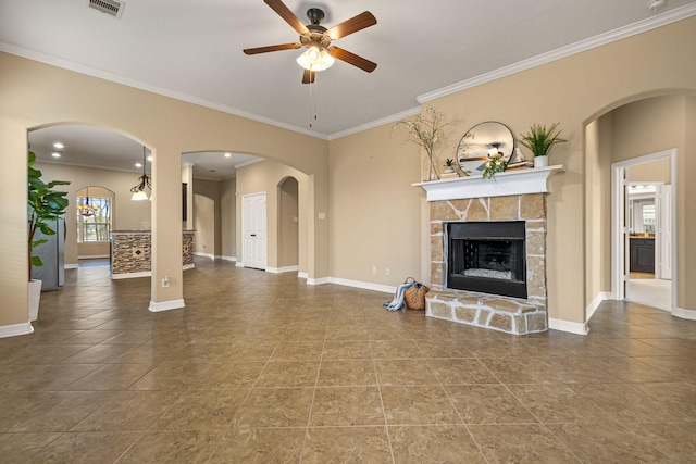 unfurnished living room with arched walkways, a fireplace, baseboards, and ceiling fan