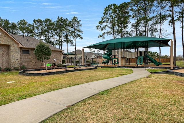 view of property's community with a lawn and playground community