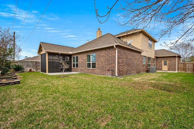 back of house featuring a patio, brick siding, a fenced backyard, and a chimney