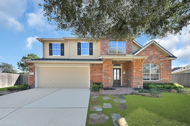 traditional-style house with fence, driveway, a front lawn, a garage, and brick siding