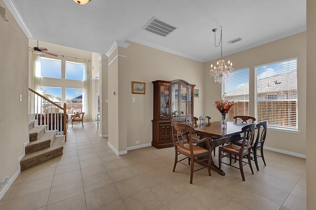 dining space featuring visible vents, a healthy amount of sunlight, and crown molding