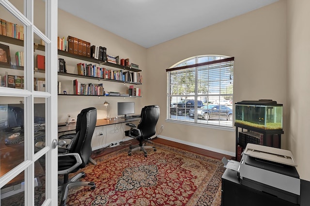 office area with wood finished floors and baseboards