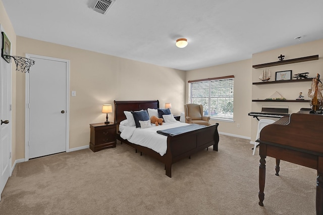 bedroom with light colored carpet, visible vents, and baseboards